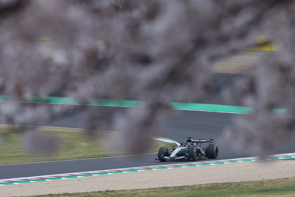Mercedes F1 car speeding on track in the distance